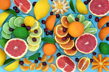 Sunshine citrus fruit high in antioxidants with oranges, lemons, limes & grapefruit also high in anthocyanins, lycopene, fibre & vitamin c. Health care concept to boost the immune system.