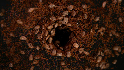 Rotating Coffee Beans in coffee grinder, Black Background.