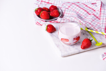A glass of homemade organic strawberry yogurt with fresh berries
