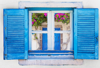 Iconic blue wooden window on white stone wall of typical Greek house, Greece - Powered by Adobe