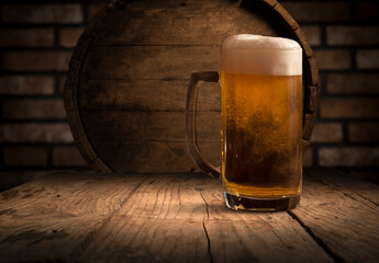 Beer barrel with beer glass on table on wooden background