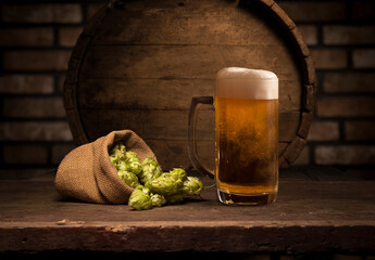 Beer barrel with beer glass on table on wooden background
