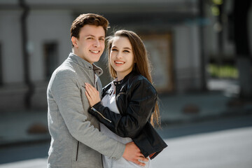  young happy beautiful couple  walking in the street.