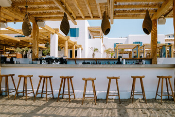 Paralia Platis Gialos beach Mykonos, Petinos beach Mikonos island Greece, luxury beach bed chairs, and blue ocean. Mykonos Greece April 2018 - obrazy, fototapety, plakaty