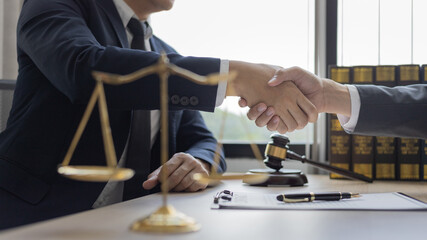 Fototapeta na wymiar Businessman shaking hands with a lawyer or judge After signing the contract and the agreement is complete, Approval of an agreement between business and law, End of the legal case.