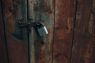 Metal padlock on old wooden gate, rustic rural wallpaper, wood texture on old door