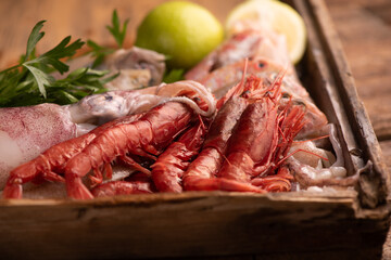 Fresh fish on the counter at a fish store with red prawns from mazara del vallo