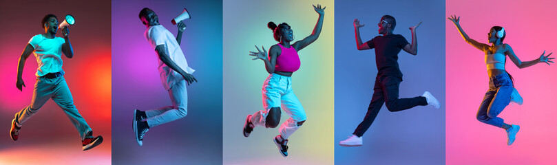 Group of people, young joyful women and men jumping isolated over multicolored neon backgrounds. - obrazy, fototapety, plakaty