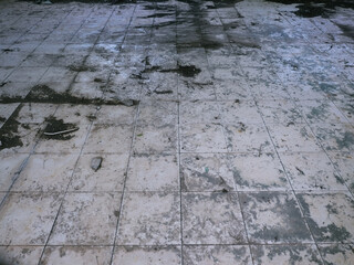 The heavily soiled tiled floor has not been cleaned.