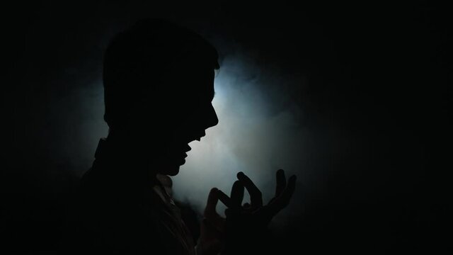 Zombie at night bares his teeth and growls