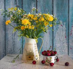 Still life with ripe berries and fragrant wildflowers.
