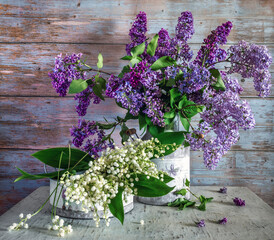 Fototapeta na wymiar Beautiful bouquets of freshly cut white and fragrant lilies of the valley and lilacs.