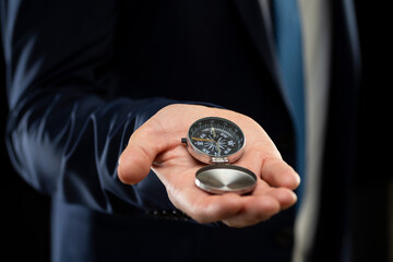 Businessman holding a navigation compass in his hand. Business planning and business navigation for...