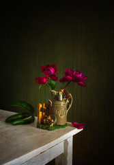 Several buds of peonies that have not yet opened in a small vase. Minimalism.