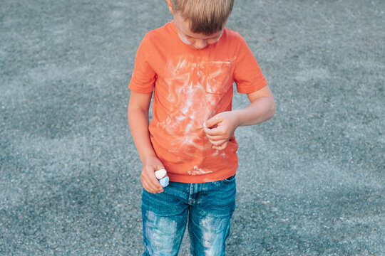 Boy showing a chalk stain on his clothes. The concept of cleaning stains on clothes. 