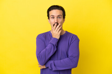 Fototapeta premium Young caucasian man isolated on yellow background surprised and shocked while looking right