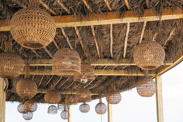 Many Eco-friendly designed rattan wicker lampshades on the ceiling