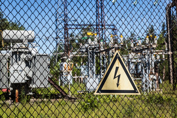 high voltage sign on the fence of an old abandoned power plant