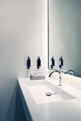 Modern white bathroom interior with stylish mirror and rectangular sink