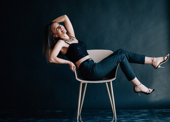 Hilarious business woman laughs in chair