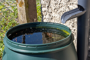 A full tank of rainwater under the gutter