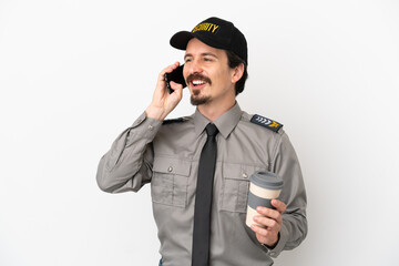 Young caucasian security man isolated on white background holding coffee to take away and a mobile