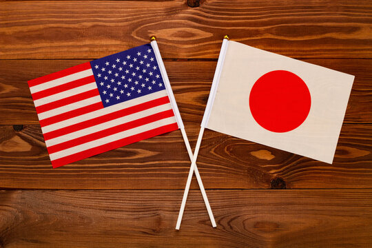 Flag of USA and flag of Japan crossed with each other. USA vs Japan. The image illustrates the relationship between countries. Photography for video news on TV and articles on the Internet and media.