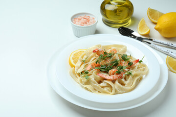 Concept of tasty eating with shrimp pasta on white background