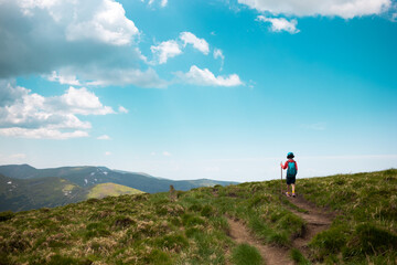 Naklejka premium trekking in the mountains with a child