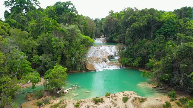 Aerial reveal of Cascadas Roberto Barrios waterfalls in Mexico, tropical scene