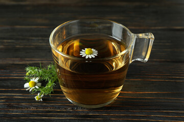 Cup of chamomile tea on rustic wooden table