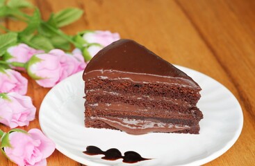 A piece of chocolate cake on the white dish.