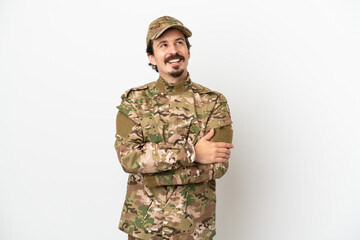 Soldier man isolated on white background looking up while smiling