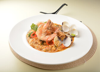 stir fried dry bee hoon mee noodle with mixed seafood lala shell and prawn in Thai tomyum spicy sauce asian halal menu
