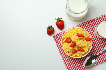 Concept of tasty breakfast with cornflakes on white background