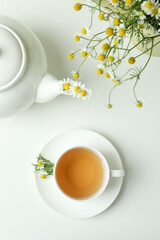 Concept of breakfast with chamomile tea on white table