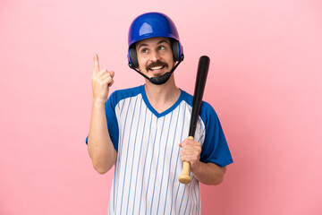 Young caucasian man playing baseball isolated on pink background pointing up a great idea
