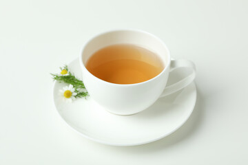 Cup of chamomile tea on white background