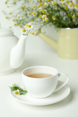 Concept of breakfast with chamomile tea on white table