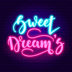 Sweet dreams. Glowing pink neon incription on dark brick wall background