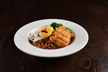 stir fried dry instant noodle mee indo in dark soya sauce with fried egg and crispy chicken chop asian halal menu