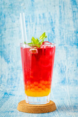 Fruity Bubble Tea in glass cup on blue background