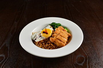 stir fried dry instant noodle mee indo in dark soya sauce with fried egg and crispy chicken chop asian halal menu