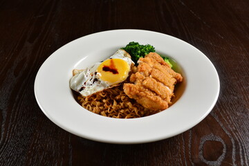 stir fried dry instant noodle mee indo in dark soya sauce with fried egg and crispy chicken chop asian halal menu