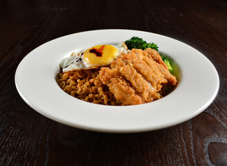 stir fried dry instant noodle mee indo in dark soya sauce with fried egg and crispy chicken chop asian halal menu