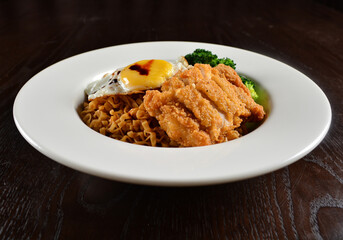 stir fried dry instant noodle mee indo in dark soya sauce with fried egg and crispy chicken chop asian halal menu