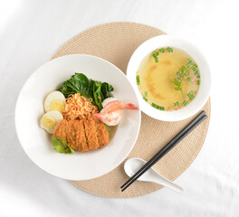 stir fried dry instant noodle mee indo in dark soya sauce with fried egg and crispy chicken chop...