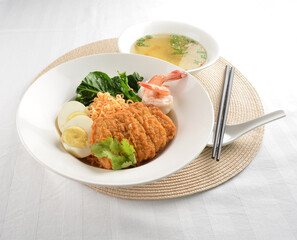 stir fried dry instant noodle mee indo in dark soya sauce with fried egg and crispy chicken chop and soup asian halal menu