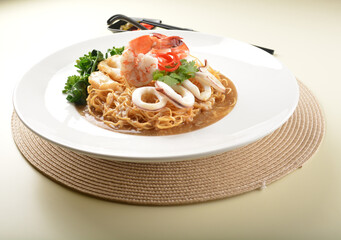 deep fried crispy yellow noodle mee with seafood big prawn and vegetable in thick gravy sauce asian menu