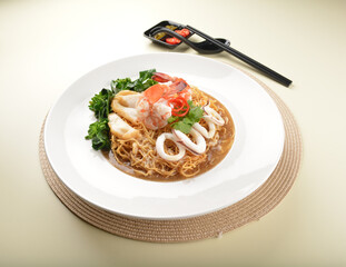 deep fried crispy yellow noodle mee with seafood big prawn and vegetable in thick gravy sauce asian menu
